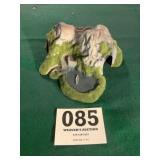 Mountain past train tunnel with lake