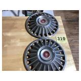 2 old hubcaps for a Ford Mustang