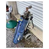 Golf clubs with bag, golf balls, and cart