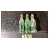 Three old glass Coca-Cola bottles embossed from