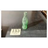 Vintage and embossed six fluid ounce Coca-Cola