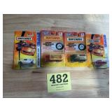 4 matchbox toy cars still in original packaging