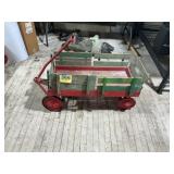 Antique toy wagon thatï¿½s made of metal and wood.