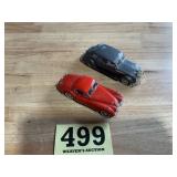 Lots of two older style toy cars one is a jaguar