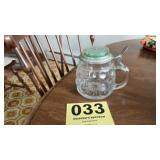 Beautiful glass mug with silver lid and a game