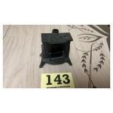 Vintage cast-iron still bank shaped as a wood