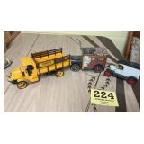 Three toy trucks two of them are banks and one is