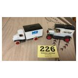 Two advertising toy truck banks one for West