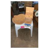 Wooden pumpkin and birdfeeder. White table