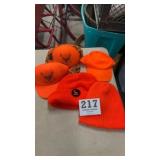 Five orange hunting hats