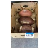 Three footballs