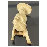 Carved ivory 1 3/4"H figure with wide rim hat
