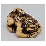 Netsuke- carved ivory crouching figure with