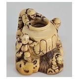 Netsuke- Antique carved ivory figures at the well