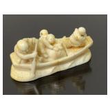 Netsuke, figures in a boat, signed