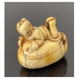 Netsuke, 1 3/8"H figure on a sack
