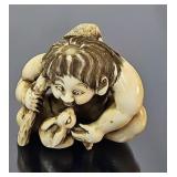 Antique ivory Netsuke, boy with rabbit, signed