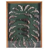 VINTAGE ICONIC CAST IRON CAP GUNS FRAMED - (26)