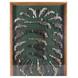 VINTAGE ICONIC CAST IRON CAP GUNS FRAMED - (26)