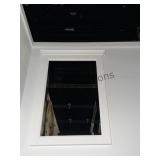 A Decorative White Picture Frame Mounted On A Plai