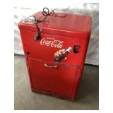 Five cent Coca-Cola machine cools approximately