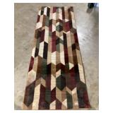 It has a 2 foot rug approximately 2.7 x 7.4