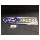 Metal Ford trucks sign approximately 22 x 5