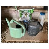 Two watering cans and fertilizer