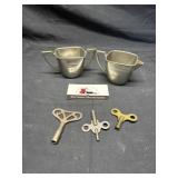 Pewter cream and sugar and clock keys