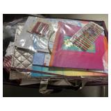 Bag of wrapping paper, bags, and ribbon