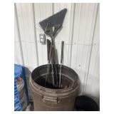 Garbage can with misc tools and golf clubs