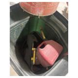 Garbage can with gas cans and misc