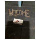 Cast-iron welcome sign