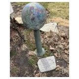Gazing ball on stand and garden stone