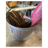 Galvanized garbage can full of yard tools