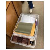 Tote of office supplies and paper