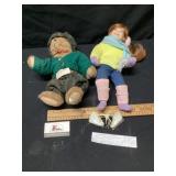 Stuffed bear and doll