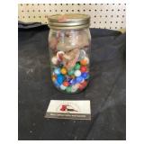 Mason jar of marbles and crystal rocks