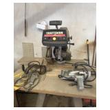 Drills and radial arm saw on stand