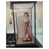 Oriental doll in display case