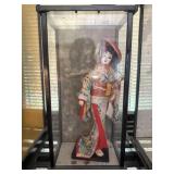 Oriental doll in display case
