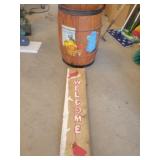 Trash bin and wooden welcome sign