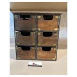 Primitive wooden drawers in metal stand
