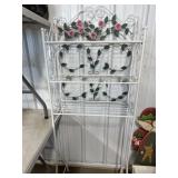 Ornate metal rose over the toilet stand