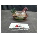 Modern colored glass hen on nest
