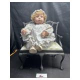 Cast iron bench with doll
