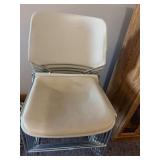 Stack of metal frame chairs