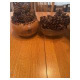 Decorative bowls and pine cone decor