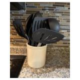 Stoneware canister of kitchen utensils