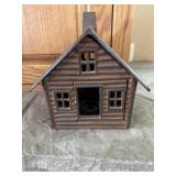 Cast-iron cabin candle holder